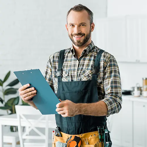 industry-water-treatment a smiling plumber holding a clipboard
