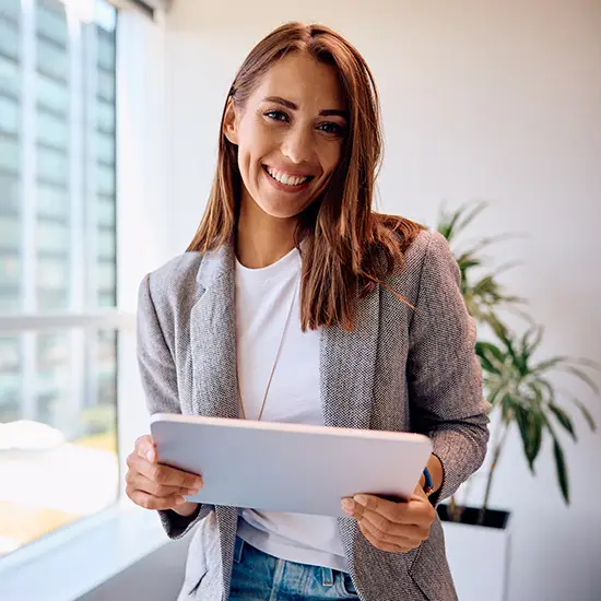 young marketing executive holding a tablet in her office